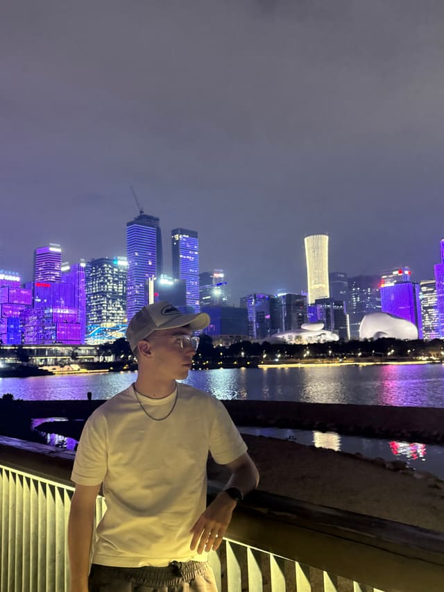 Maximilian Richter at a railing in Shenzhen, skyline behind.